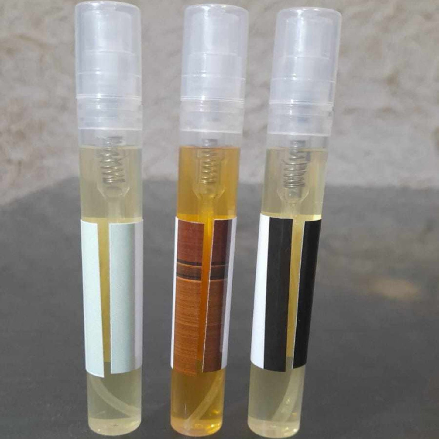 Back side of 3 perfume tester set showing label and theme for each fragrance