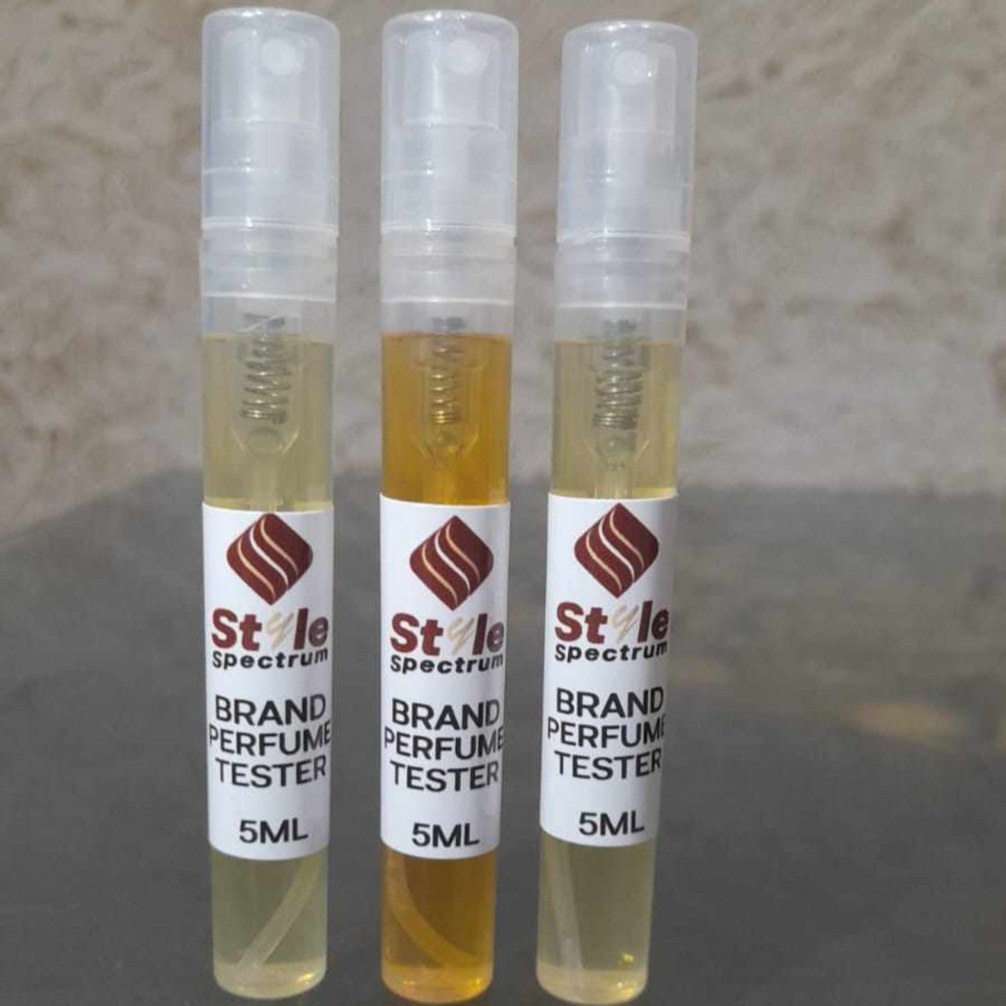 Front view of 3 perfume tester set including Amber Illumination, Oud Triumph, and Floral Essence 5ml bottles
